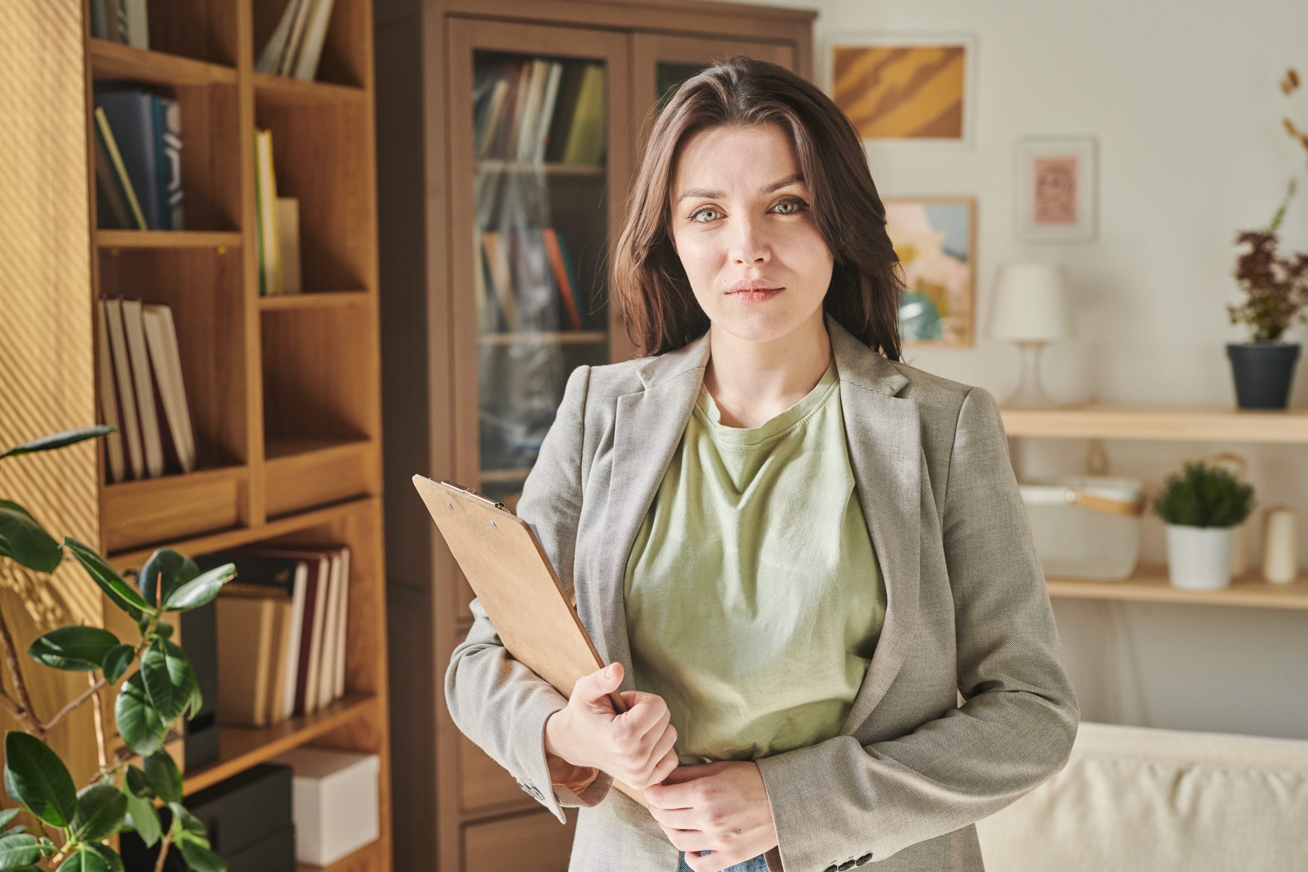 Professional woman in business attire holding a clipboard