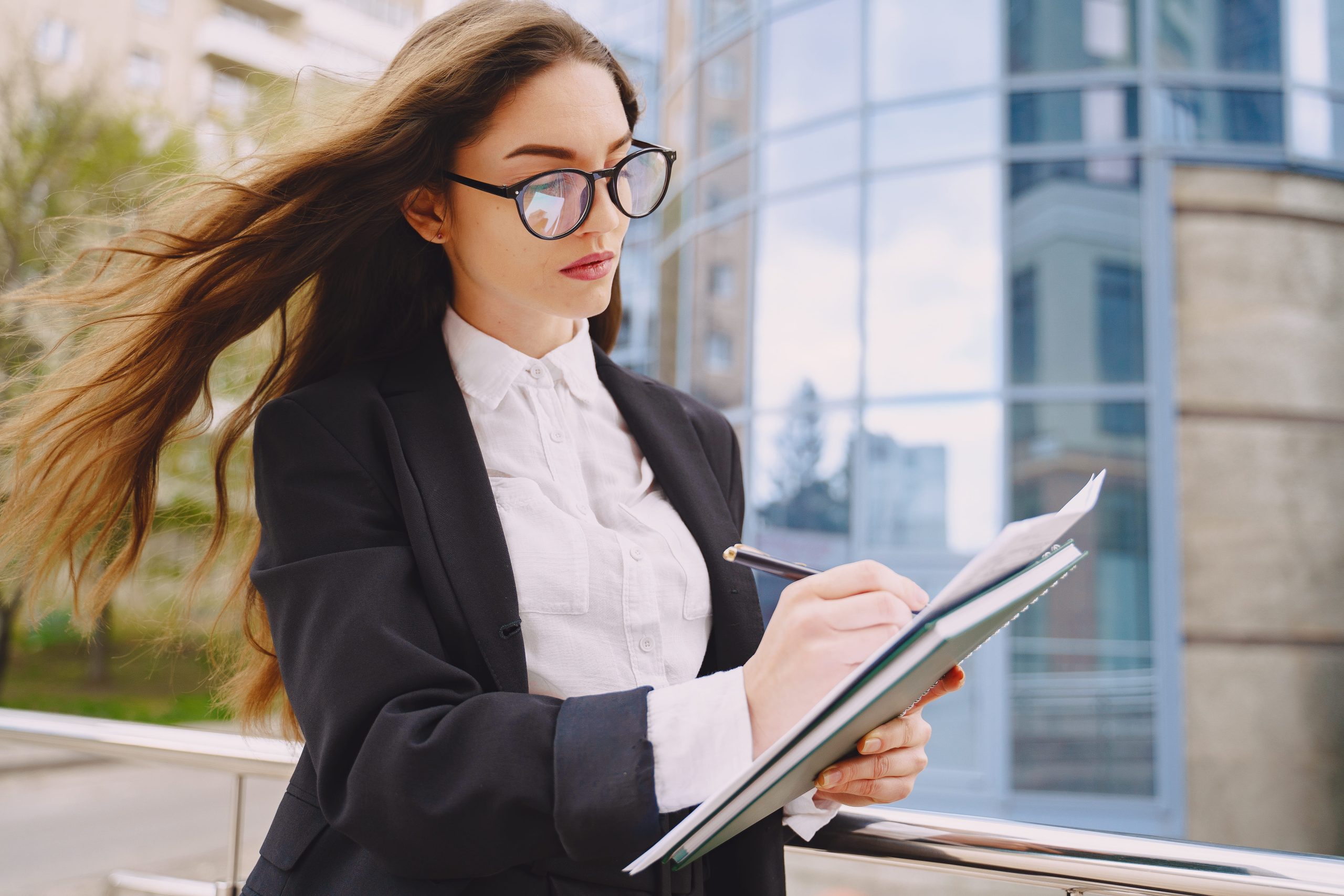 Businesswoman standing outdoors in city office environment representing Professional Legal Support