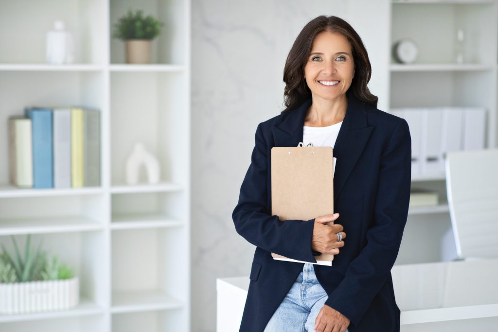 Confident mature woman posing in a modern office