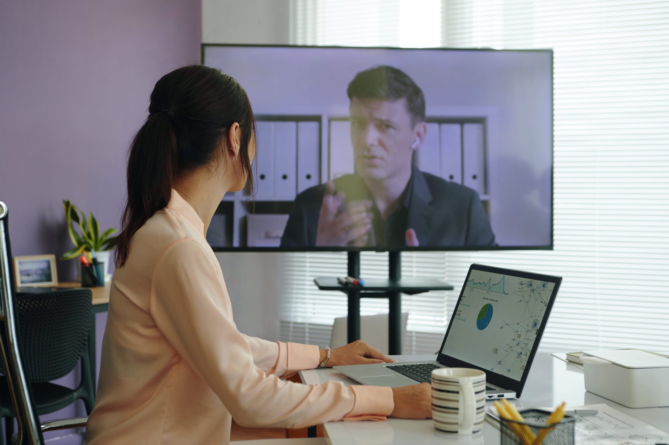 Woman talking with colleague during online meeting for Zoom Depositions