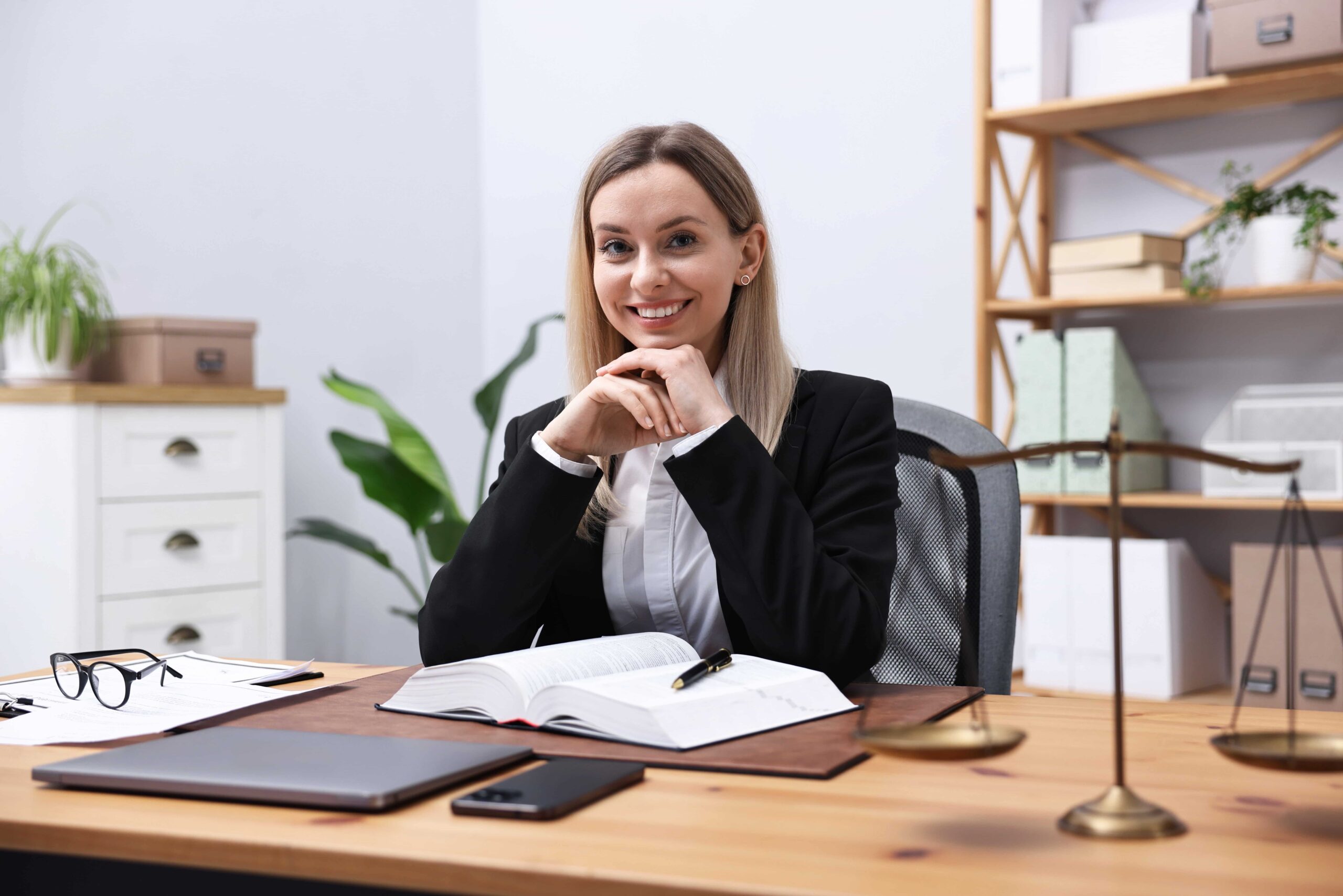 Confident female lawyer seated at her desk in a professional office