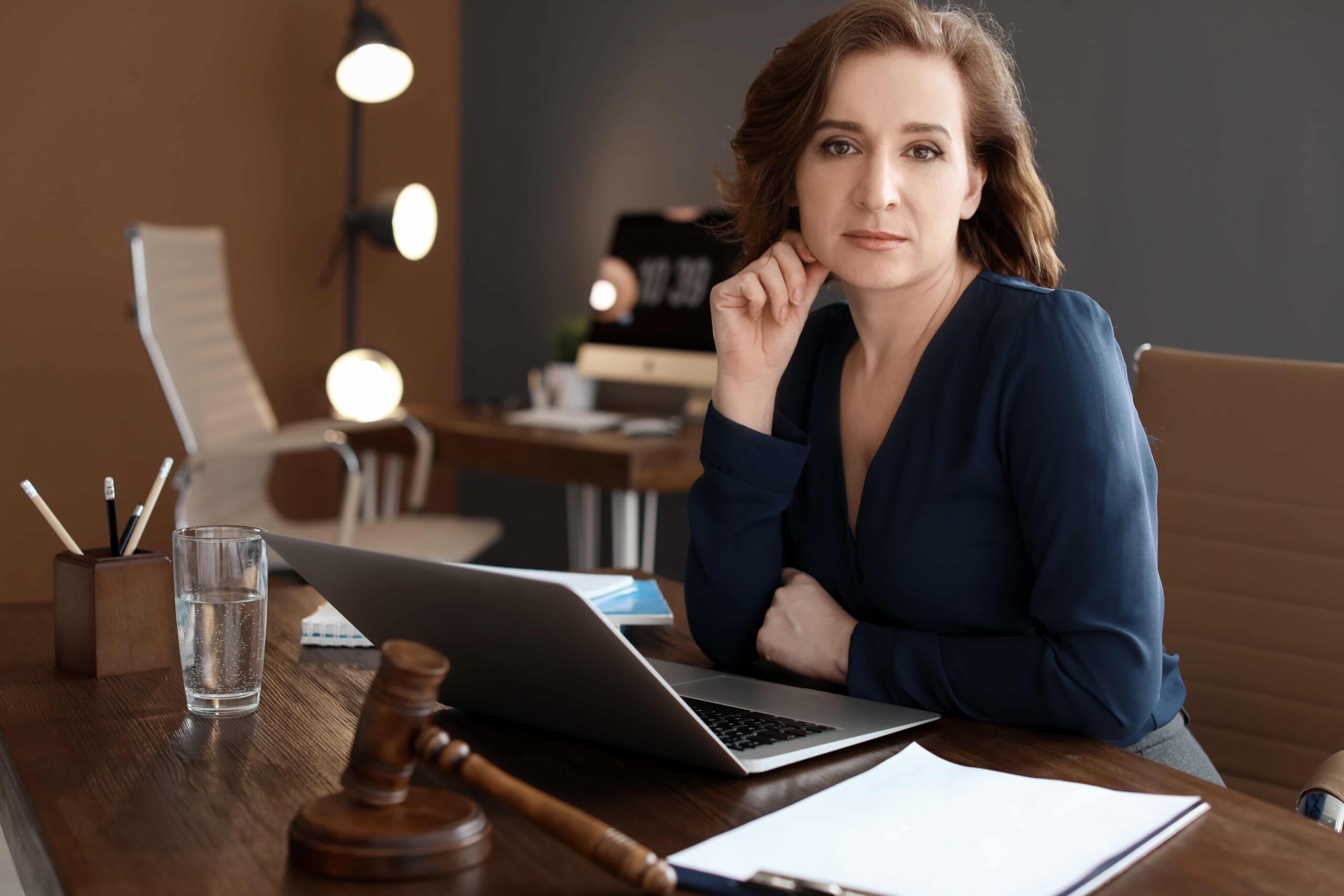 Woman lawyer at desk with gavel and laptop