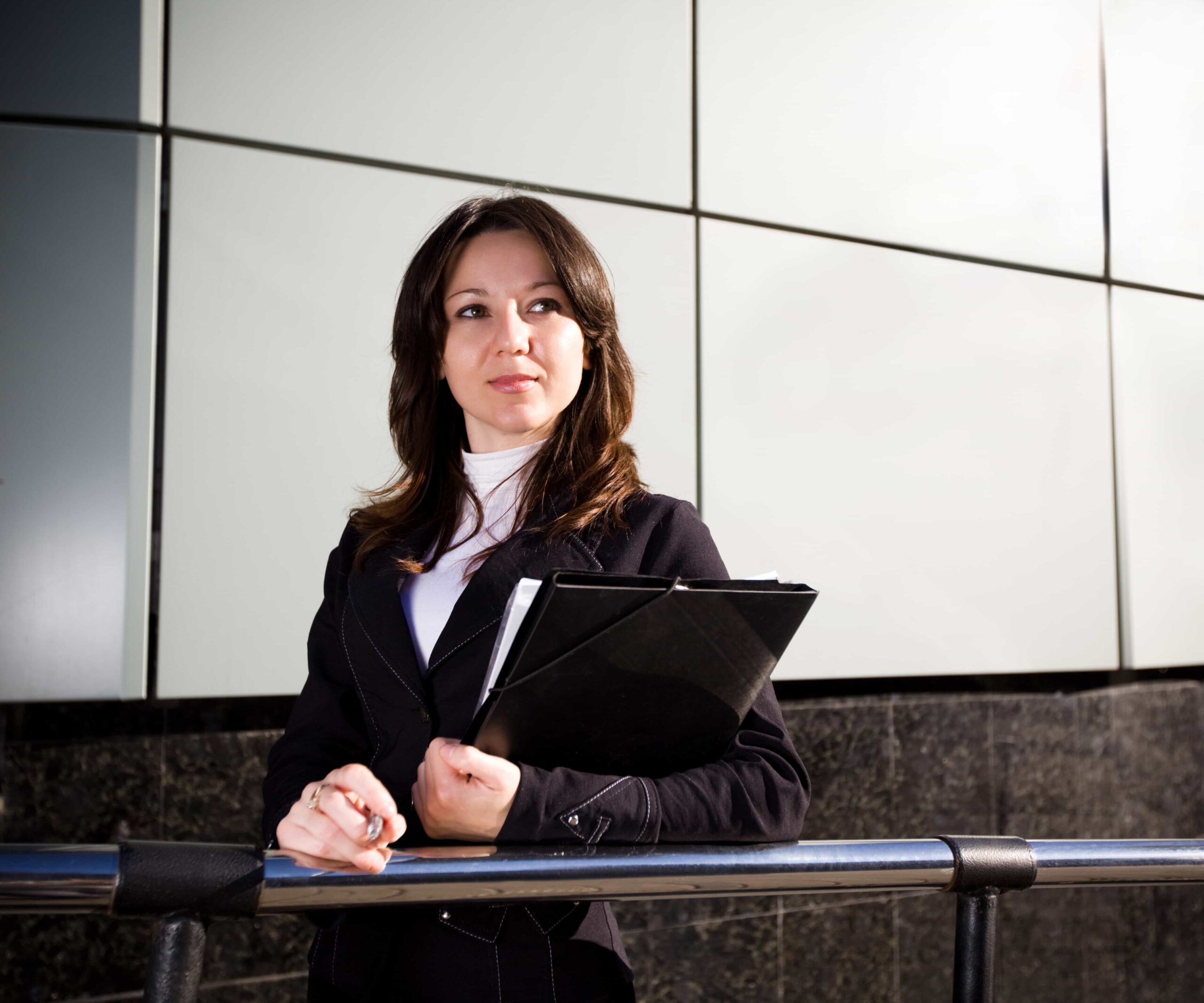 Professional woman holding a folder outside a building