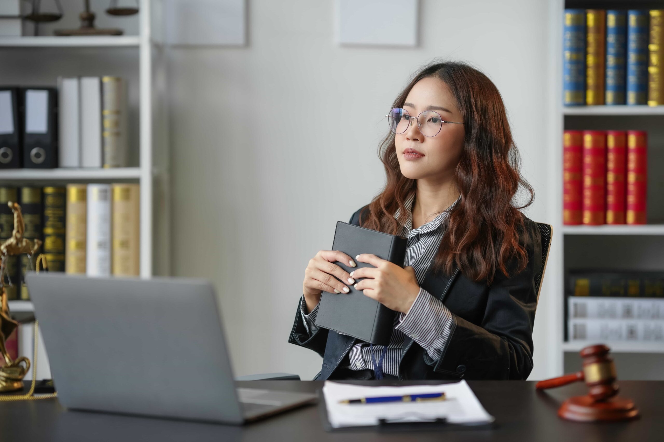 Serious pensive lawyer working at desk in office representing Full-Service Court Reporting
